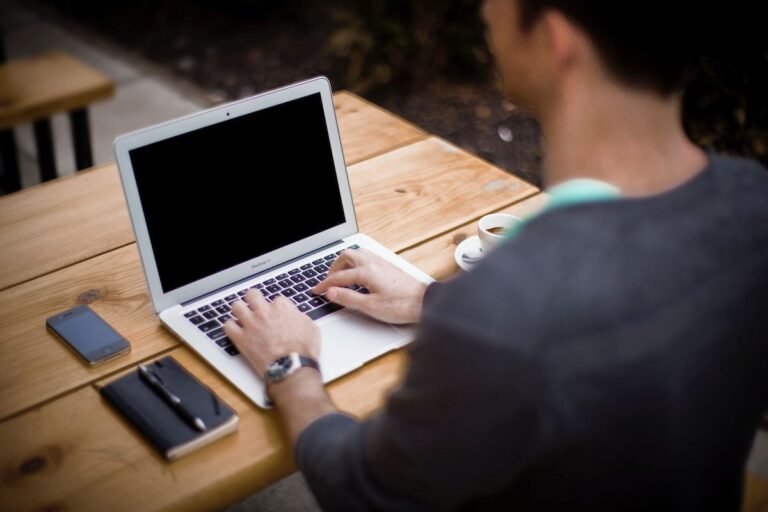 Certified coder entering charges and codes on a laptop